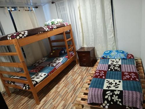 a bedroom with two bunk beds in a room at Casa Puente de Boyaca in Tunja