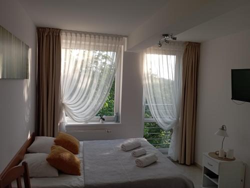 a bedroom with a bed and a large window at Apartament Sea Planet Mielno Centrum - parking w cenie pobytu in Mielno