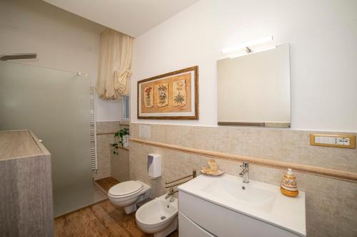 a bathroom with a sink and a toilet and a mirror at Sweet dreams in Montefiascone