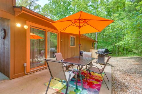 a table and chairs with an umbrella on a patio at Hot Tub and Fire Pit Holiday Island Getaway! in Golden