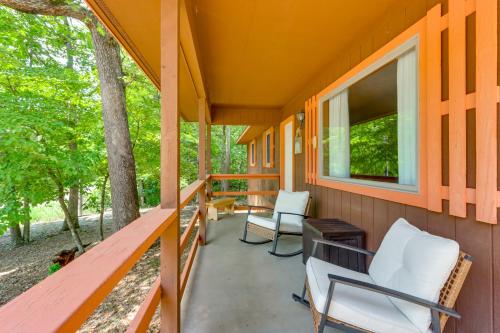 a porch with two chairs and a window at Hot Tub and Fire Pit Holiday Island Getaway! in Golden