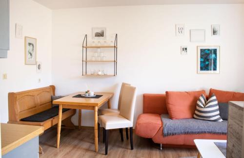 a living room with a couch and a table at Ferienwohnungen Germania in Schönau am Königssee