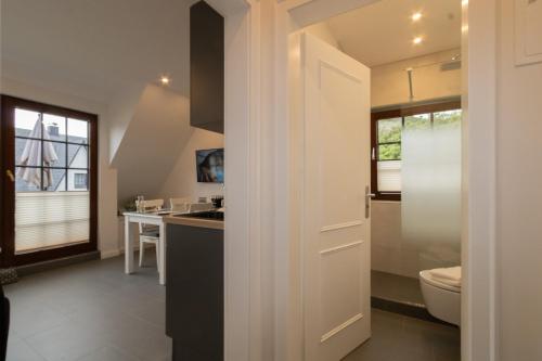 a bathroom with a toilet and a sink at Rüm Hart II, Weestersir in Hörnum