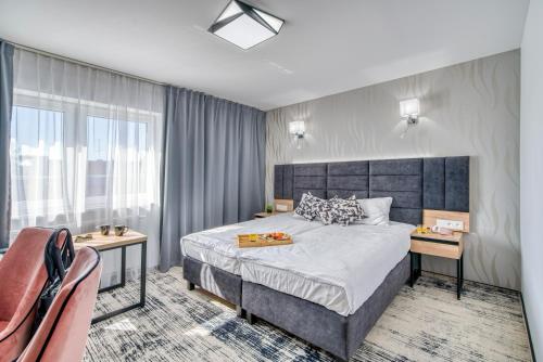 Ένα ή περισσότερα κρεβάτια σε δωμάτιο στο Acodomo Apartamenty
