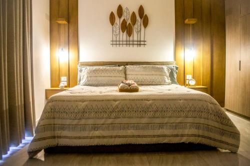 a bedroom with a bed with a teddy bear on it at Marina Cerritos Loft Wave Pool and Amenities in Mazatlán