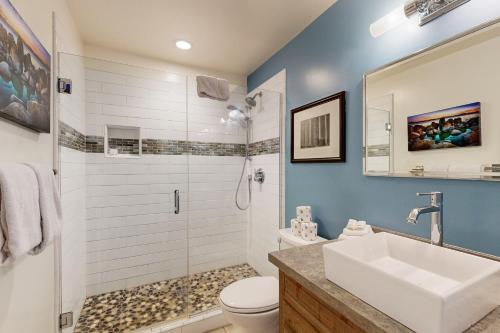 a bathroom with a toilet and a sink and a shower at Forest Pines Condo 1 - 46 in Incline Village
