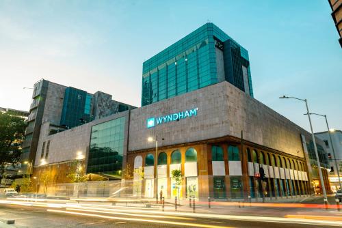 a building with a sign on the side of it at Wyndham Monterrey Ambassador Centro in Monterrey