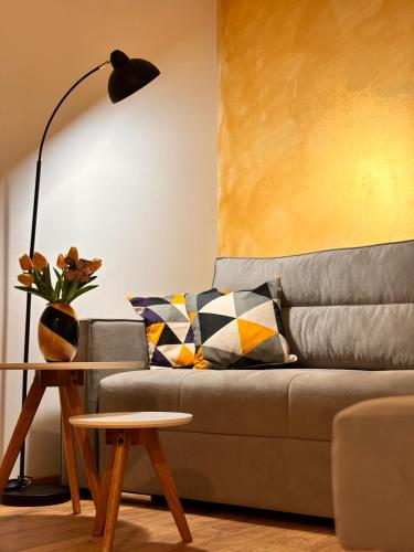 a living room with a couch with a table and a lamp at Apartman AN12 in Neum