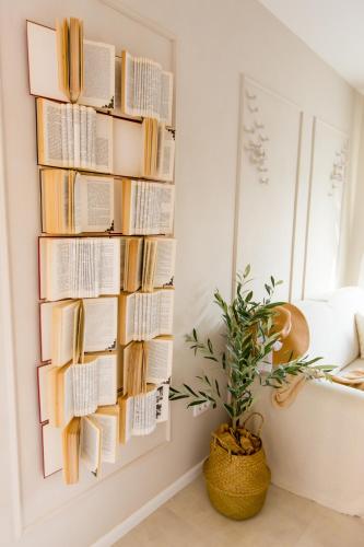 a book rack filled with books in a room with a plant at Back in Time Luxury Dubrovnik 2 in Dubrovnik