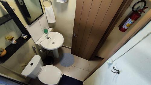 a small bathroom with a toilet and a sink at Cabana Casa Enxaimel in Picada Cafe