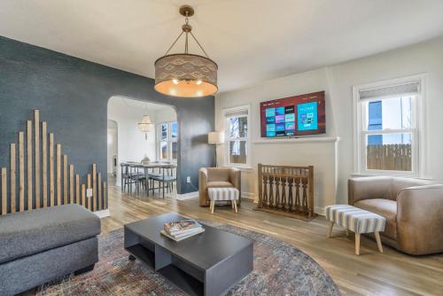 a living room with a couch and a table at Pikes Adventure - Downtown King Scenic Views in Colorado Springs