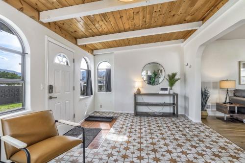 a living room with white walls and a wooden ceiling at Pikes Adventure - Downtown King Scenic Views in Colorado Springs