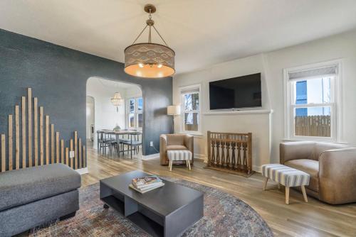 a living room with a couch and a table at Pikes Adventure - Downtown King Scenic Views in Colorado Springs