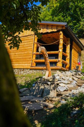 a log cabin with a fence in front of it at Na samote u lesa in Revúca