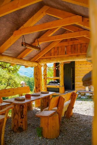 a large wooden table and chairs in a cabin at Na samote u lesa in Revúca