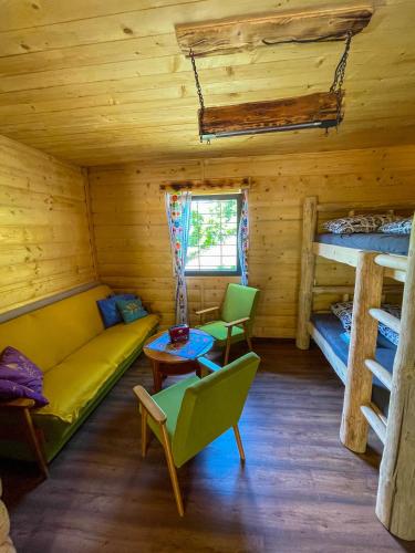 a room with a couch and two bunk beds at Na samote u lesa in Revúca