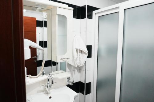 a bathroom with a sink and a mirror at Hotel Mediterrane in Sarandë