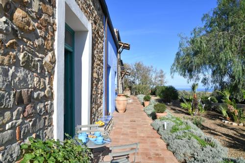 a patio with a table and chairs next to a building at Terre Di Himera in Buonfornello