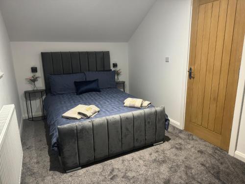 a bedroom with a bed with two towels on it at Newly constructed town house next to the canal in Keighley