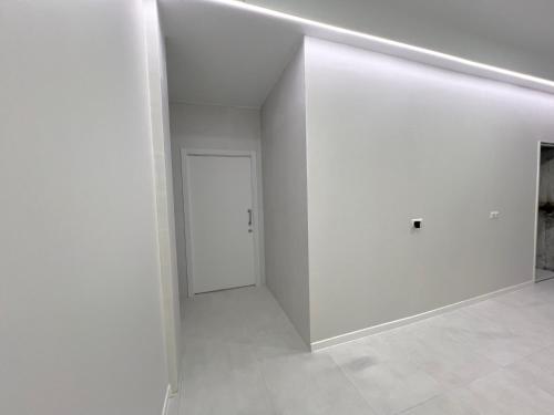 an empty room with a white wall and a door at Hostel OASIS in Madrid