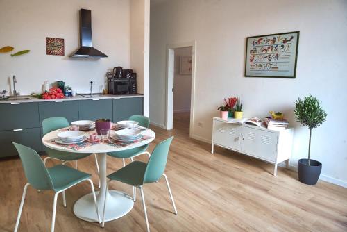 a kitchen and dining room with a table and chairs at Casa Colombo in Grosseto