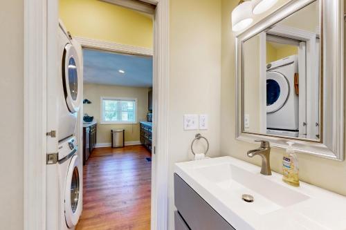 a bathroom with a sink and a washer and dryer at Town of Ocean View --- 26 Central Ave in Ocean View