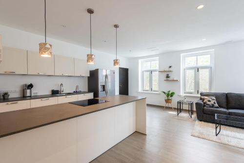 a kitchen and living room with a large counter top at Willemstad Historic City Suites in Willemstad