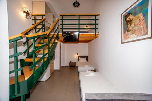 a room with a green staircase and a bed at Sophia seaview suites & restaurant in Nea Vrasna