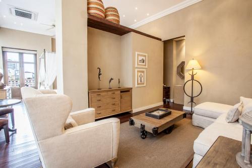 a living room with two chairs and a table at Bastión Luxury Hotel in Cartagena de Indias