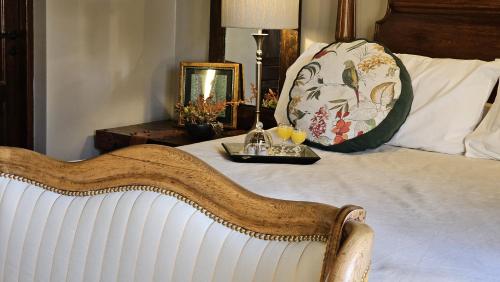 een wit bed met een dienblad met eten erop bij Villa Vicuña Wine & Boutique Hotel in Cafayate