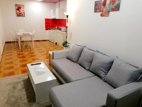 a living room with a couch and a table at TRI KRALJA - THREE KINGS Apartments in the center with private parking in Imotski