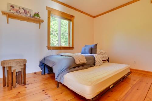 a bedroom with a bed and a window at Catskills Cabin Rental with Hot Tub and Amazing Views! in Stamford