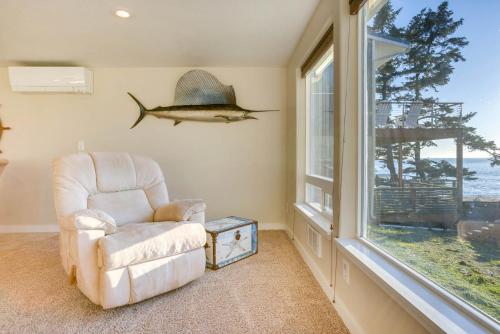 a living room with a chair and a window at Ocean Front Condo! Spectacular Ocean Views! Walk to Everything! in Depoe Bay