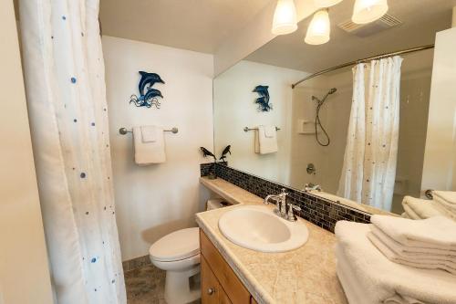 a bathroom with a sink and a toilet and a mirror at Ocean Front Condo! Spectacular Ocean Views! Walk to Everything! in Depoe Bay