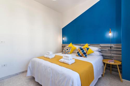 a bedroom with a large bed with towels on it at LuEDa House - Trasfertisti e Turisti in Surbo
