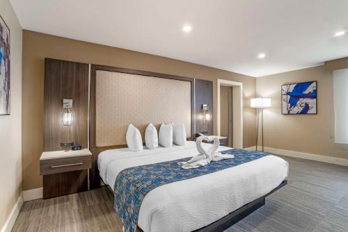 a hotel room with a large bed with a white towel on it at Best Western Plus Greenville I-385 Inn & Suites in Greenville