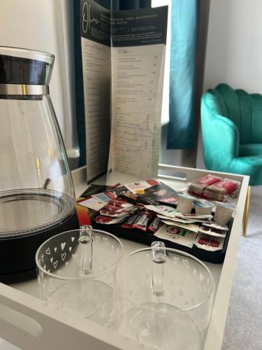 a table with two clear glasses and a blender at Olive Restaurant and Wine bar in Tottington