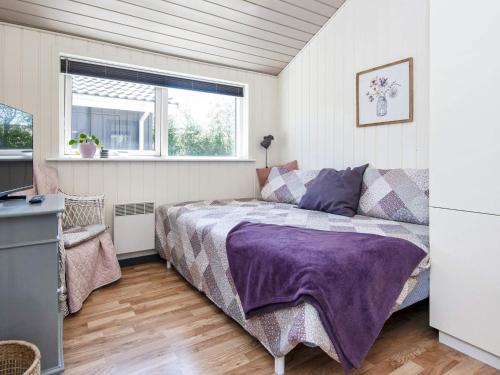 a bedroom with a bed and a window at Holiday home Tarm XLIV in Tarm