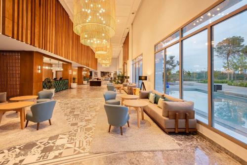 a lobby with couches and tables and a pool at Radisson Blu Resort Al Hoceima in Al Hoceïma
