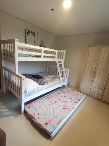 a bedroom with two bunk beds in a room at Pico De Loro Room Rate in Nasugbu
