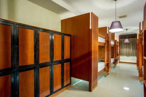 a room with wooden cabinets and bunk beds at Phangan Pearl Hostel in Haad Rin