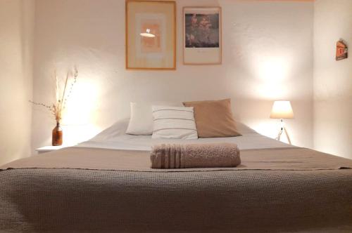 a bedroom with a large bed with two pillows at Casa Calma in Colonia del Sacramento