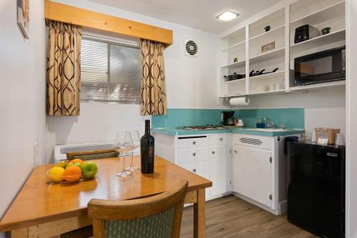 a kitchen with a wooden table with a bottle of wine at Skylark Shores Resort in Lakeport
