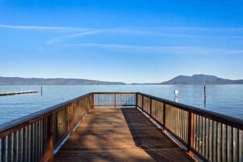 a wooden dock in the middle of a body of water at Skylark Shores Resort in Lakeport