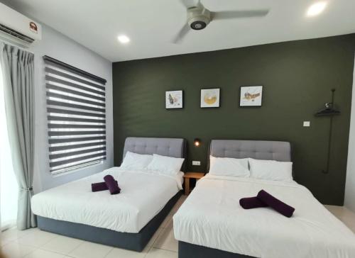 two beds sitting next to each other in a room at 2Houses with A Huge Private Pool 8 Bedrooms & 8 Bathrooms in Kuah