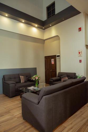 a living room with two couches and a table at Hotel D'Carlo Class in Arequipa