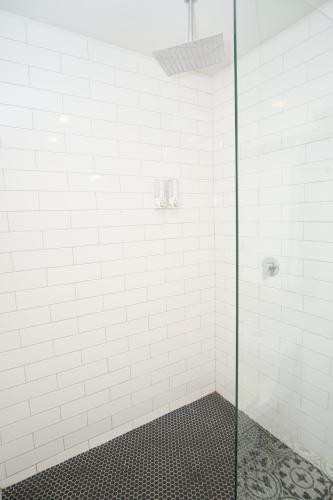 a bathroom with a shower with a glass door at Rio Suites in Tijuana