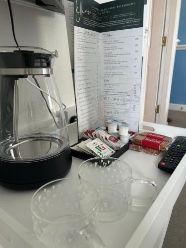 a kitchen counter with a blender and glasses on it at Olive Restaurant and Wine bar in Tottington