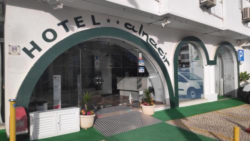 a store front with a sign on the side of a building at Hotel Alnacir in Faro