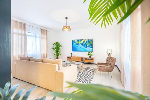 a living room with a couch and a table at Lighthouse view- POOL VILLA in Porto Moniz